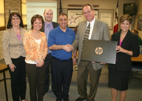 Five new HP laptops are heading to the Miller Middle School language arts department thanks to a grant from the EMC Insurance Foundation. Representatives from EMC were on hand Monday night to present the laptops to the district and be recognized for their contribution.