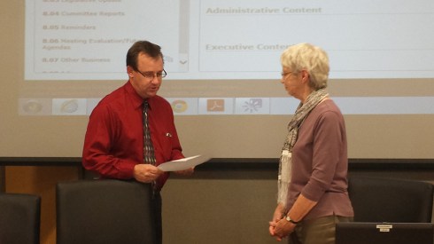 Kevin Posekany administers the oath of office to board president Kay Beach.